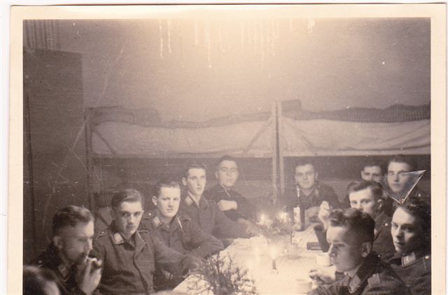 Special Christmas party set up in the barrack - those definitely look like bunks in the background. We see 'Poldi 4th back on the left.