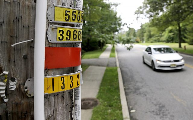 Another eruv attached to a utility pole - this one with two white pipes and large numbers