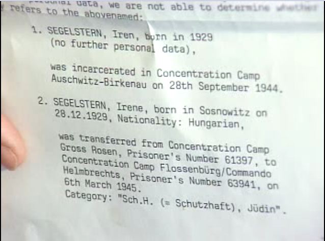 A Red Cross document is held up to the camera by Irene Zisblatt