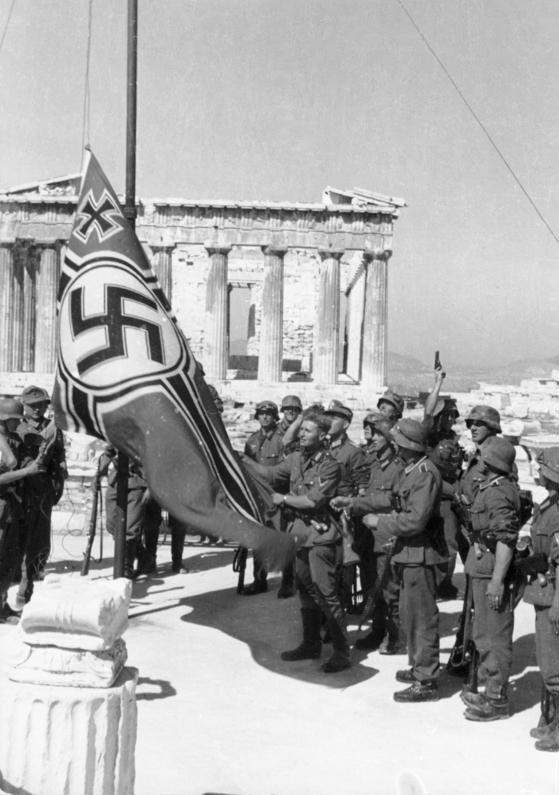 German soldiers raise the Reichskriegsflagge over the Acropolis at Athens in 1941.