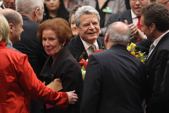 Beate and her husband are among the first to congratulate the former East German Joachim Gauck (center, facing) on his becoming the new President of Germany in 2012.
