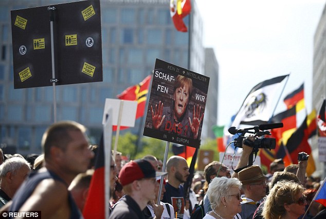 Posters of Merkel at Saturday, July 30, 2016, mass protest in Berlin
