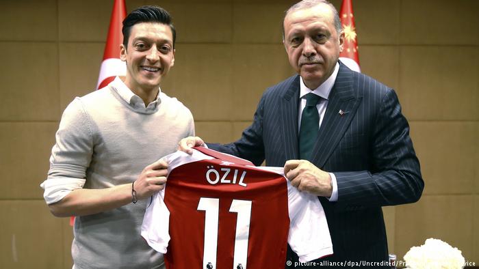 Mesut Özil, left, hands a shirt over to Recep Tayyip Erdogan on May 13