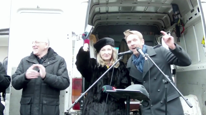 Gerd Ittner, rally organizer, Lady Michele Renouf at the podium with translator Nikolai Nerling