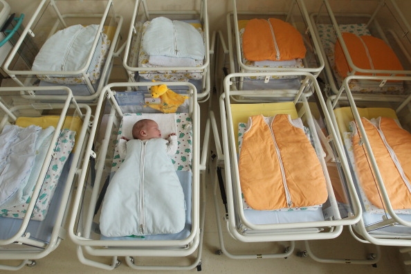 Maternity ward with many empty cradles.