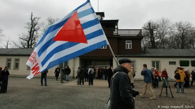 A demonstrator carrying the communist VVN organization's flag.